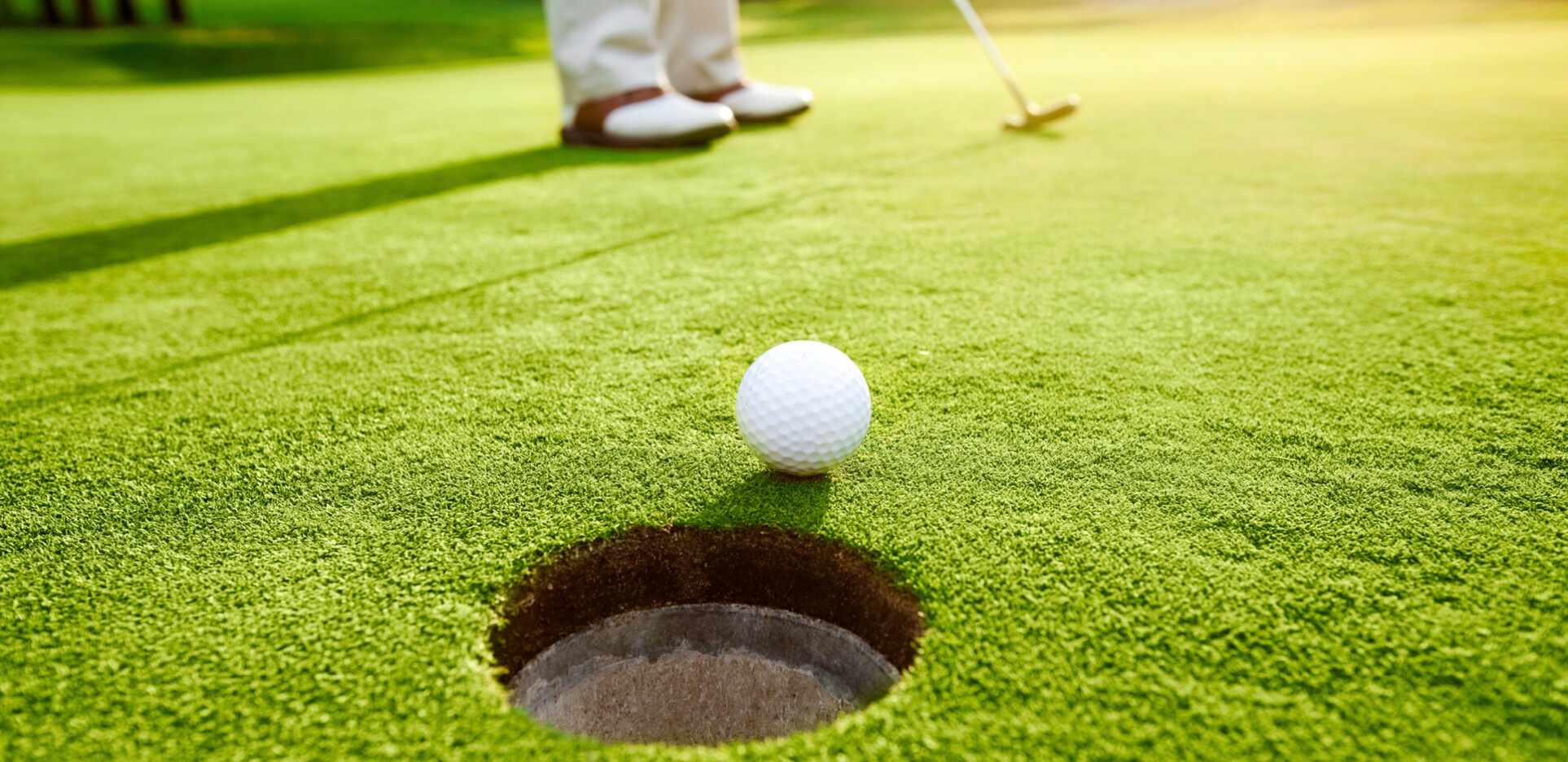 Golf ball near hole after putt from golfer 